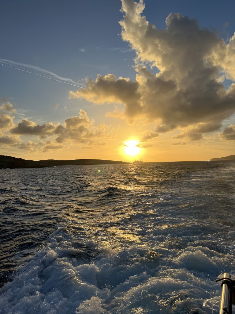 Sunset on a boat between the islands of Malta and Gozo